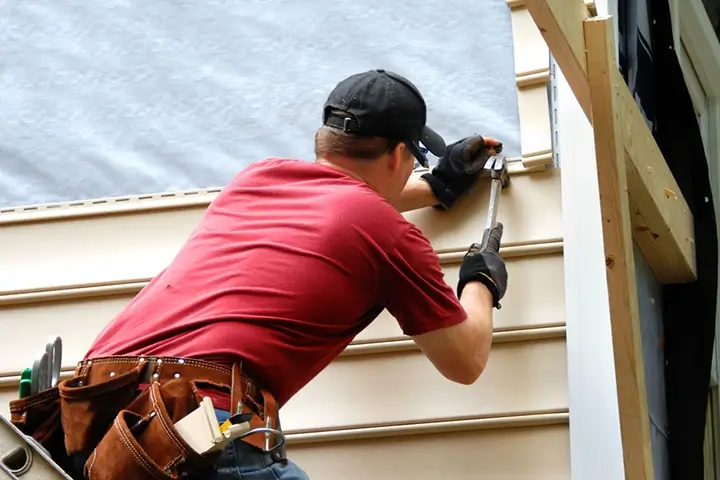 Rosemeyer Roofing LLC contractor installing siding on residential home